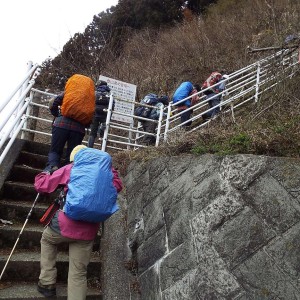 尾根末端が削り取られ、急な鉄梯子をよじ登る